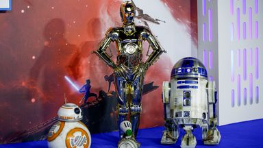 Star Wars characters R2-D2 and C3PO (right and center) receive the spinoff series